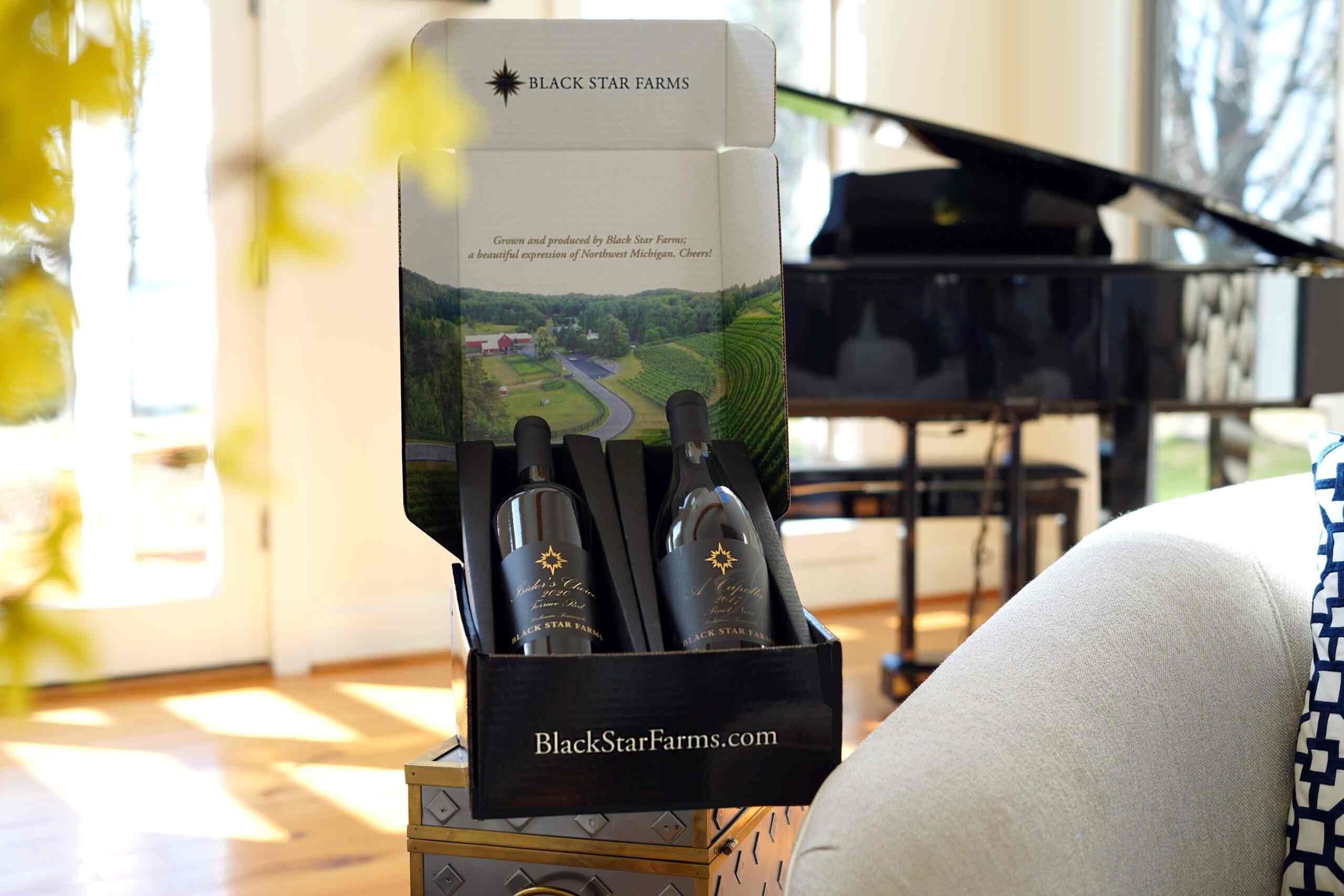 Several barrels lined up in front of a barn.