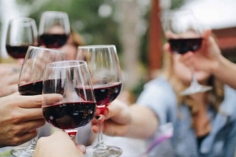 Friends clinking wine glasses in celebration.