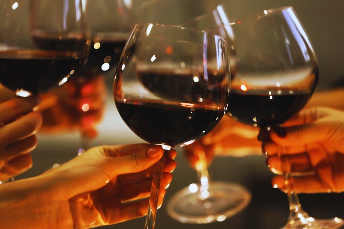 Red Wine Cheers Glasses of red wine clinking together.
