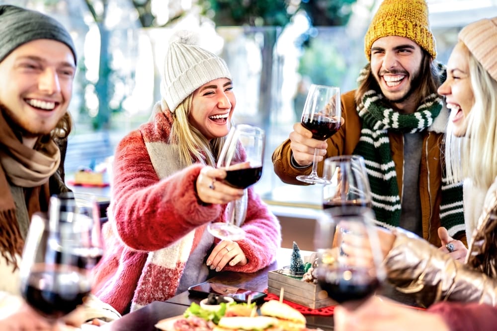 Young,Friends,Toasting,Red,Wine,At,Restaurant,Patio,-,Happy Winter Wine Tasting on the Leelanau Peninsula 1