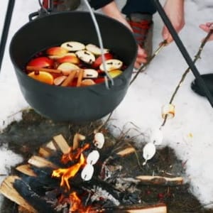 Cooking mulled wine on the fire in the winter forest. Winter Wine Ideas 2