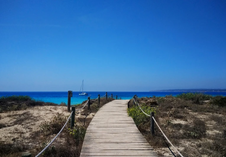 beautiful-shot-boardwalk-beach-formentera-spain Several barrels lined up in front of a barn.