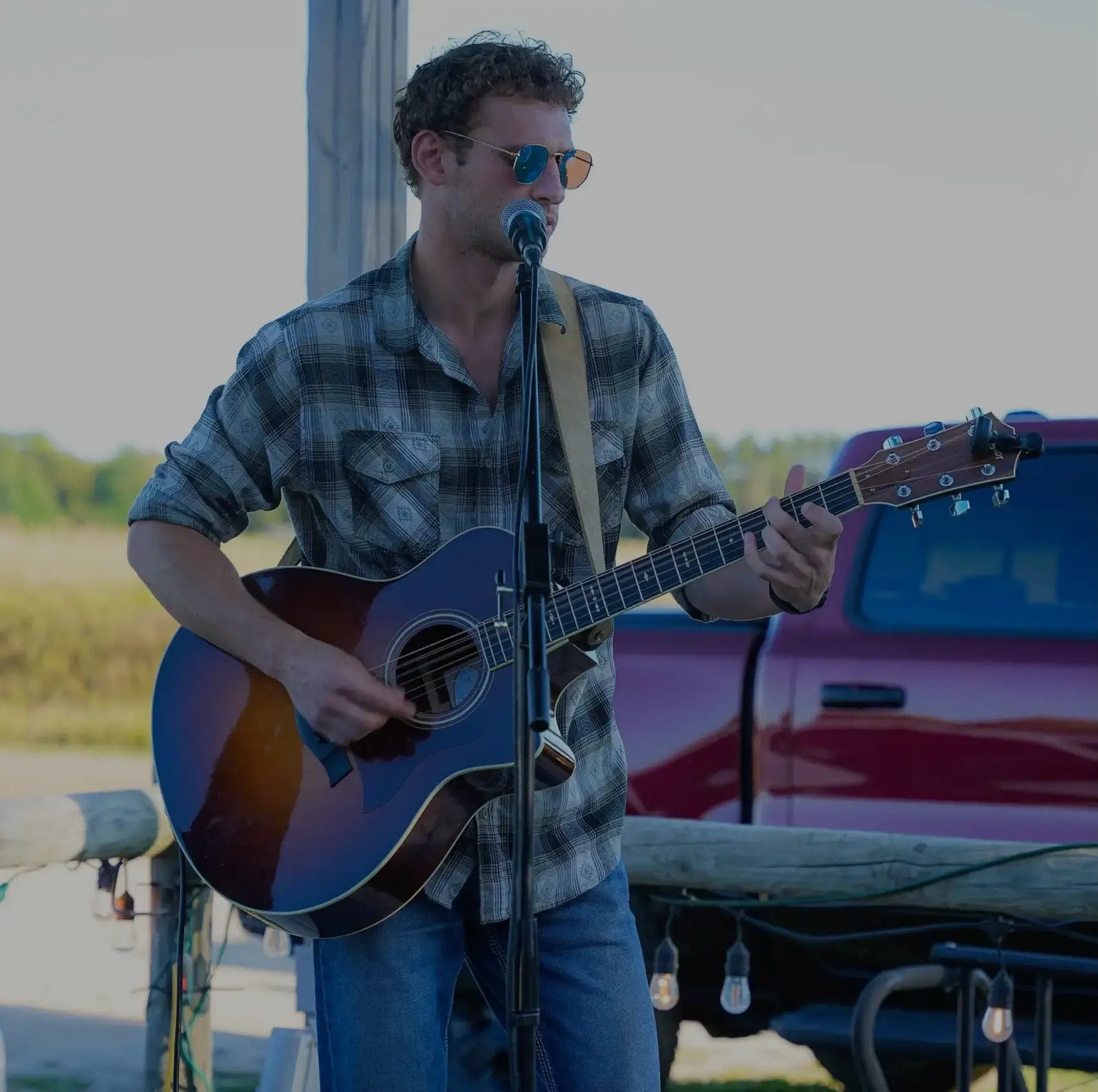 Jakob Abraham playing guitar and singing.
