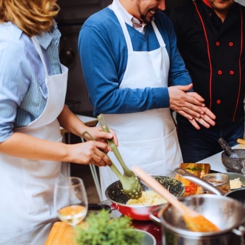 Couple in a hands-on cooking demonstration.