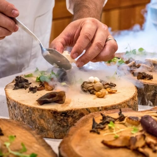 Chef preparing forest mushrooms.