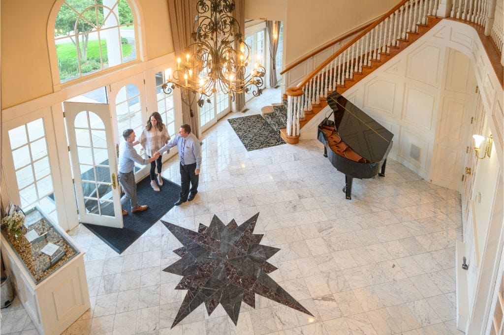 A team of individuals collaborating on a project using laptops at a table.