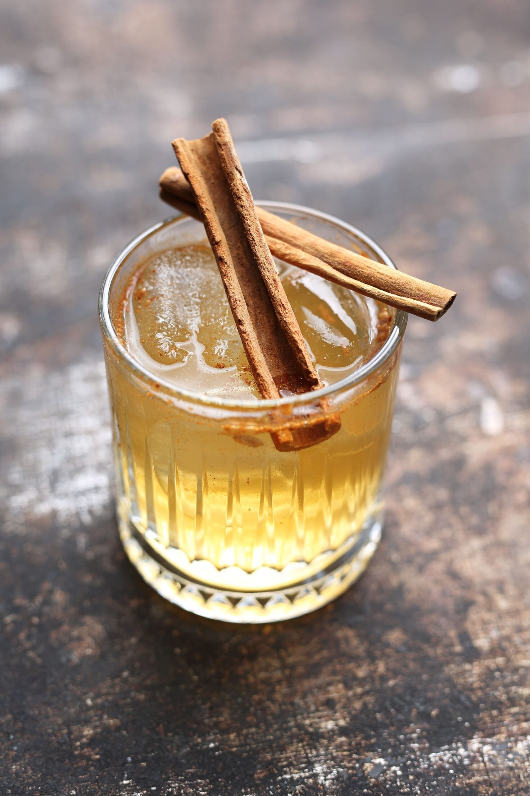 A woman leading a horse through a grassy field.