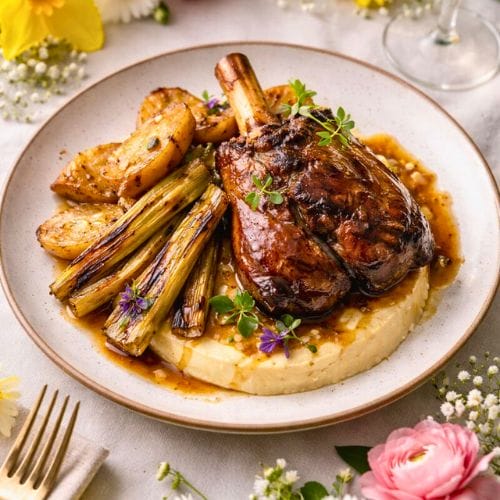 Plated entree with spring flowers on the table.
